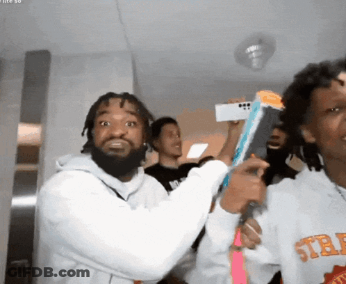 A Man Wearing A Sweatshirt That Says ' Std ' On The Front GIF