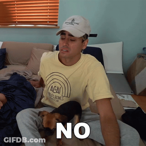 A Man Wearing A T-Shirt That Says Acai World 'S Bowls Sits On A Bed With His Dog GIF