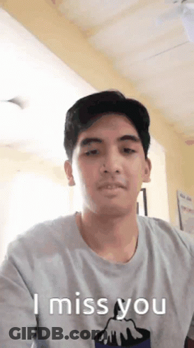 A Man Wearing A T-Shirt That Says " I Miss You " GIF