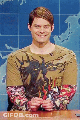 A Man Wearing A T-Shirt With A Bull On It Is Smiling GIF