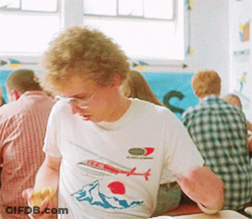 A Man Wearing A T-Shirt With An Airplane And Mountains On It GIF