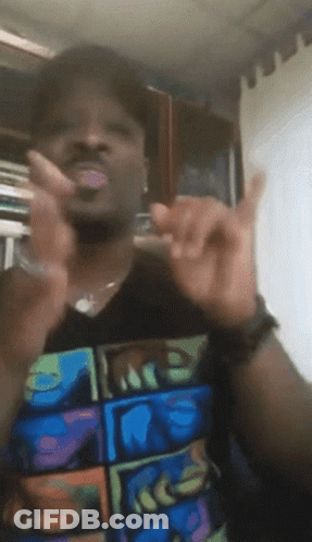 A Man Wearing A T-Shirt With The Word Face On It Is Giving A Peace Sign GIF