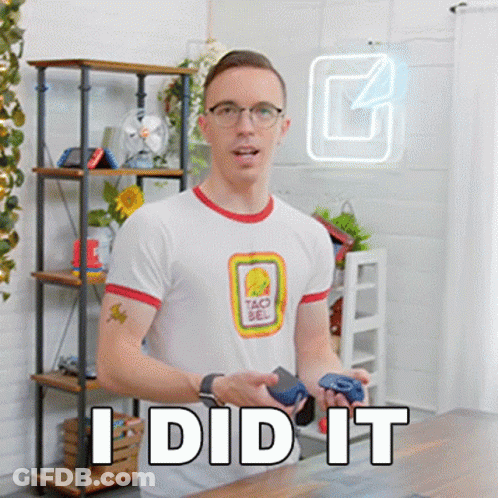 A Man Wearing A Taco Bell Shirt Is Holding A Video Game Controller And Says I Did It . GIF