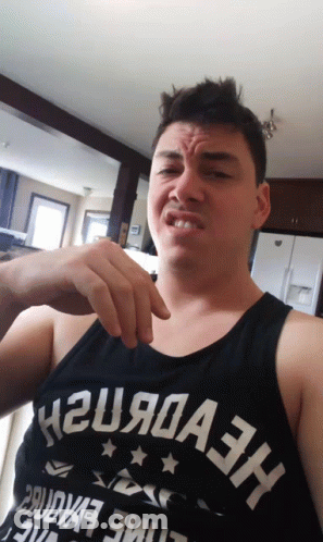 A Man Wearing A Tank Top That Says H2u9a3h Makes A Funny Face GIF