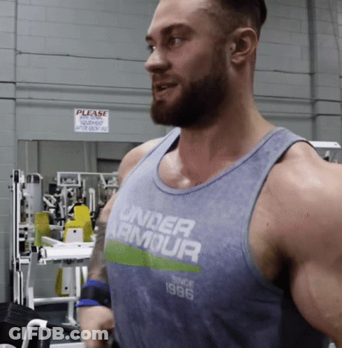 A Man Wearing A Tank Top That Says Under Armour On It GIF