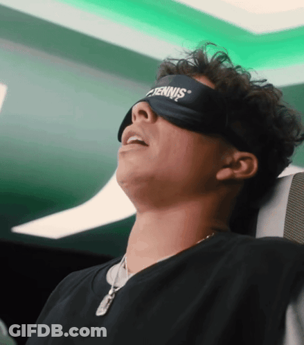 A Man Wearing A Tennis Eye Mask Is Sleeping On A Plane GIF