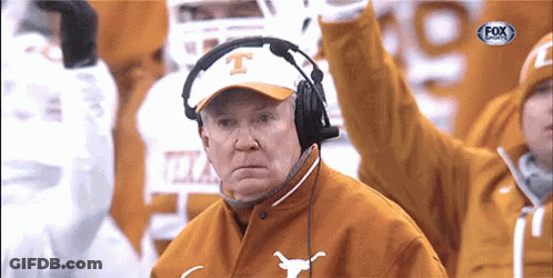 A Man Wearing A Texas Hat And Headphones Watches A Football Game GIF