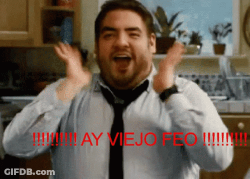 A Man Wearing A Tie And A Shirt With The Words Ay Viejo Feo On The Bottom GIF