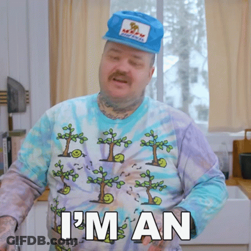 A Man Wearing A Tie Dye Shirt And A Hat Says " I 'M An " GIF