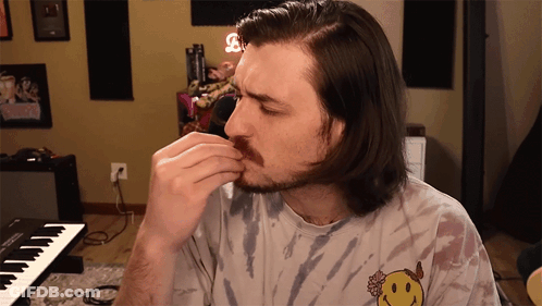 Man In Tie Dye Shirt With Smiley Face GIF