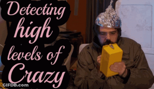 A Man Wearing A Tin Foil Hat Is Smoking A Box Of Cheese GIF
