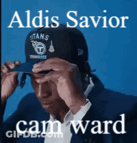 A Man Wearing A Titans Hat With The Name Aldis Savior Cam Ward On The Bottom GIF