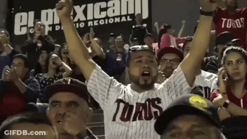 A Man Wearing A Toaus Jersey Stands In A Crowd GIF