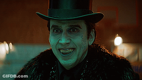 A Man Wearing A Top Hat And A Fur Coat Has Sharp Teeth GIF