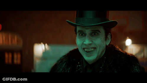 A Man Wearing A Top Hat And A Fur Coat Is Making A Funny Face GIF
