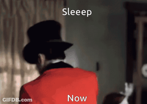 Man In Top Hat And Red Jacket Standing In Front Of Sleep Now Sign GIF