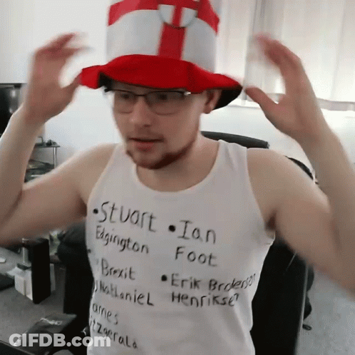 A Man Wearing A Top Hat And A Tank Top That Says Stuart Ian Edgington Foot GIF
