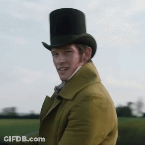 A Man Wearing A Top Hat And A Yellow Coat Is Waving GIF