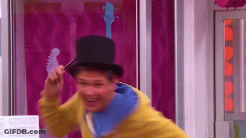 A Man Wearing A Top Hat And A Yellow Jacket GIF