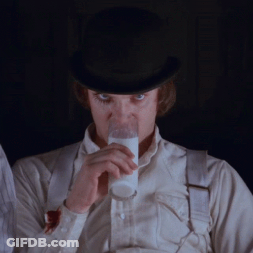 A Man Wearing A Top Hat Is Drinking Milk From A Glass GIF