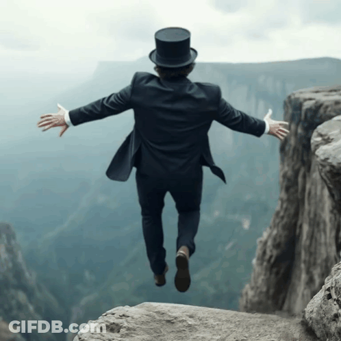A Man Wearing A Top Hat Is Jumping Over A Cliff GIF