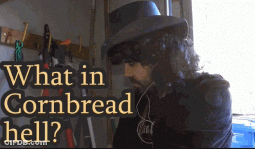 A Man Wearing A Top Hat With The Words What In Cornbread Hell Written Above Him GIF
