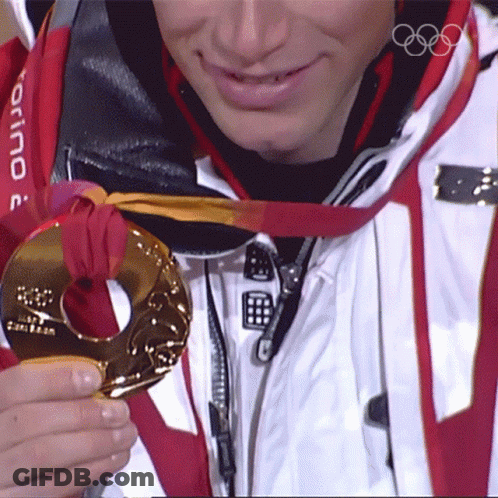 A Man Wearing A Torino Jacket Is Holding A Medal GIF
