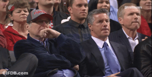 A Man Wearing A Trailblazers Hat Sits In The Stands GIF