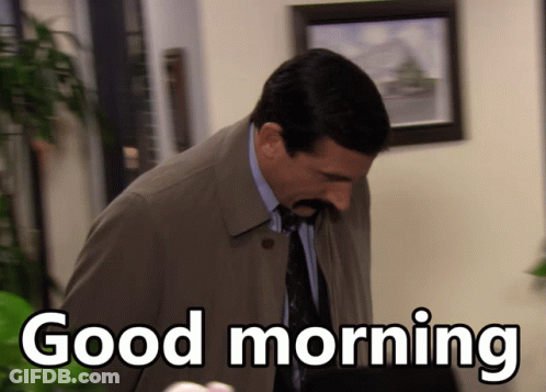 A Man Wearing A Trench Coat And Tie Says Good Morning GIF