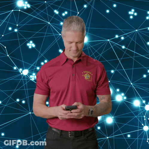 A Man Wearing A Tulsa Shirt Is Looking At His Phone GIF