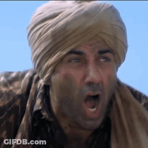 A Man Wearing A Turban And A Scarf Is Making A Funny Face GIF