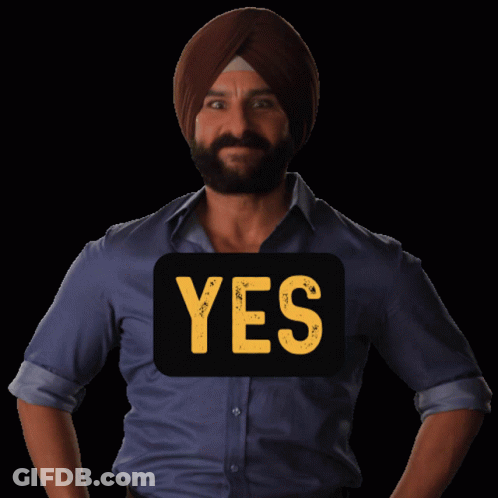 A Man Wearing A Turban Has A Yes Sign On His Shirt GIF