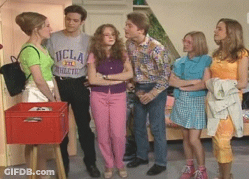 A Man Wearing A Ucla Athletic T-Shirt Talks To Three Women GIF