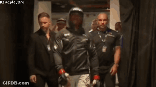A Man Wearing A Ufc Hat Walks Through A Hallway GIF