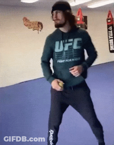 A Man Wearing A Ufc Hoodie Is Dancing GIF