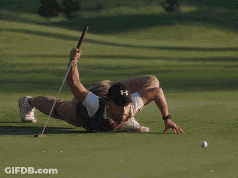 A Man Wearing A Under Armour Hat Is Playing Golf On A Green GIF