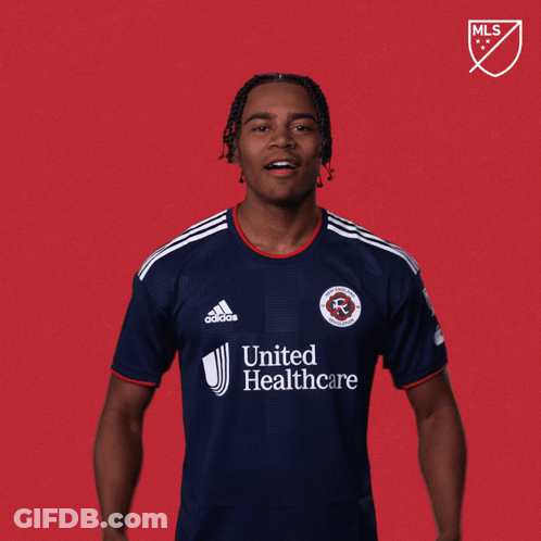 A Man Wearing A United Healthcare Jersey Stands In Front Of A Red Background That Says Let 'S Go GIF