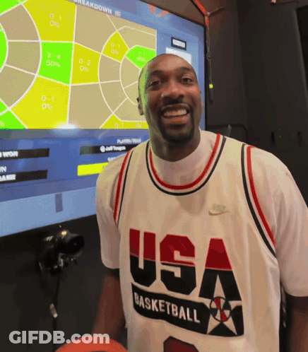 A Man Wearing A Usa Basketball Jersey Stands In Front Of A Monitor GIF