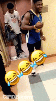 A Man Wearing A USA Shirt Is Standing Next To A Man Wearing A Gold Jersey GIF