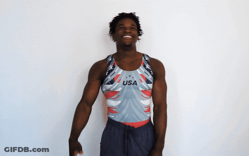 A Man Wearing A Usa Tank Top Is Smiling GIF