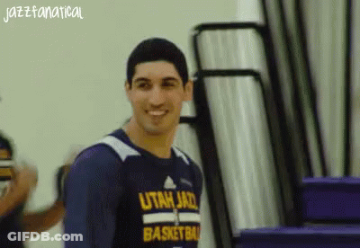 A Man Wearing A Utah Jazz Basketball Shirt Smiles GIF