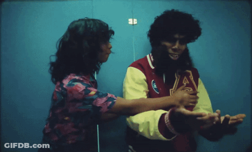 A Man Wearing A Varsity Jacket With The Letter J On The Front GIF