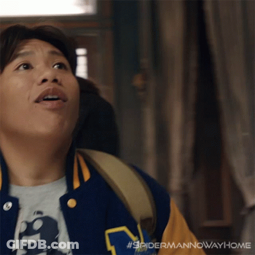 A Man Wearing A Varsity Jacket With The Letter M On The Front GIF