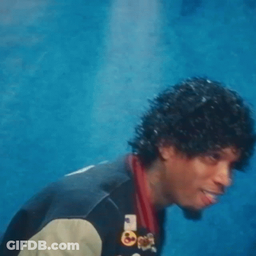A Man Wearing A Varsity Jacket With The Letter R On The Front GIF