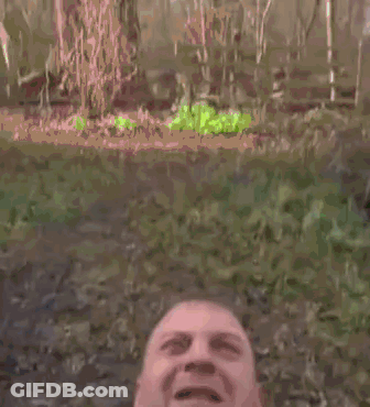 A Man Wearing A Vest And Tie Is Screaming With His Mouth Wide Open . GIF