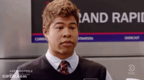A Man Wearing A Vest And Tie Is Standing In Front Of A Sign That Says Rand Rapid GIF