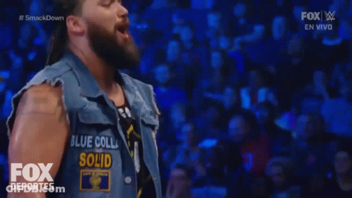 A Man Wearing A Vest That Says Blue Colla Solid On It GIF