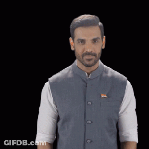 A Man Wearing A Vest With A Flag On It GIF