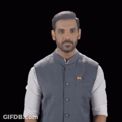 A Man Wearing A Vest With An Indian Flag On It Holds His Hand Up GIF