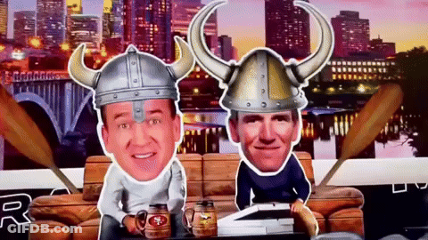 A Man Wearing A Viking Hat Sits Next To Another Man GIF